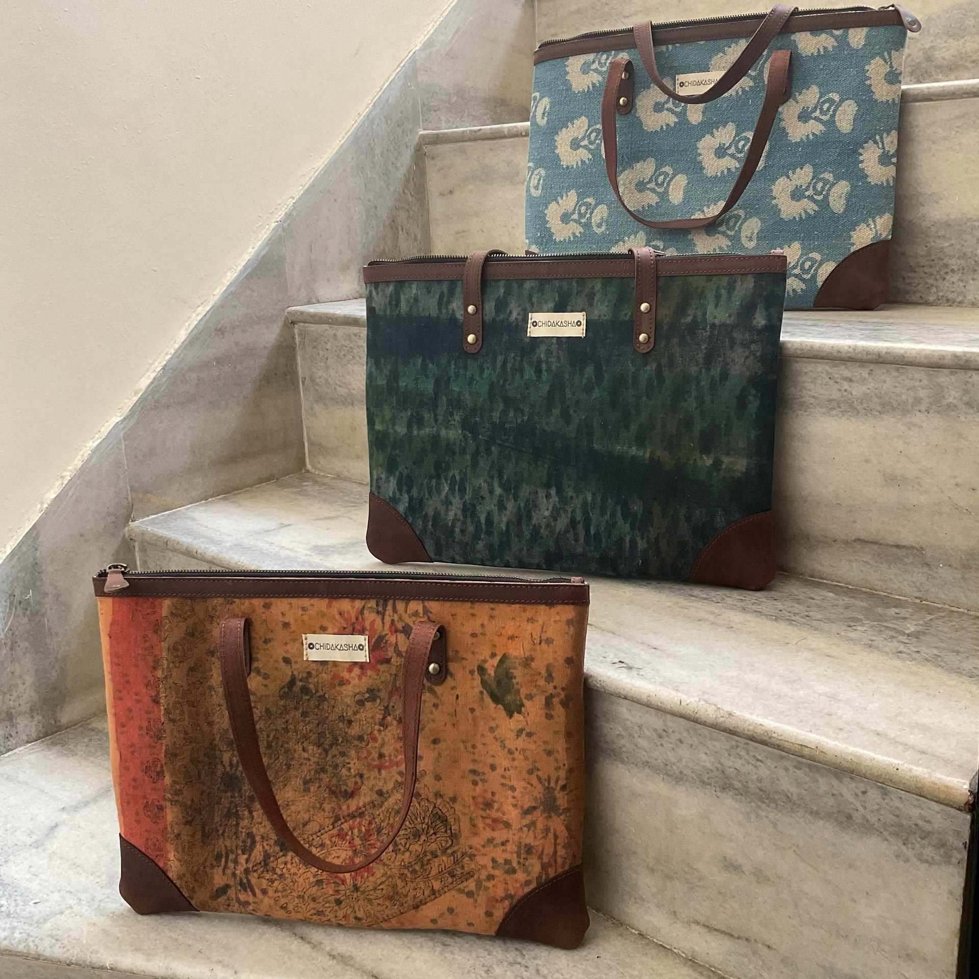 a couple of bags sitting on top of a set of stairs